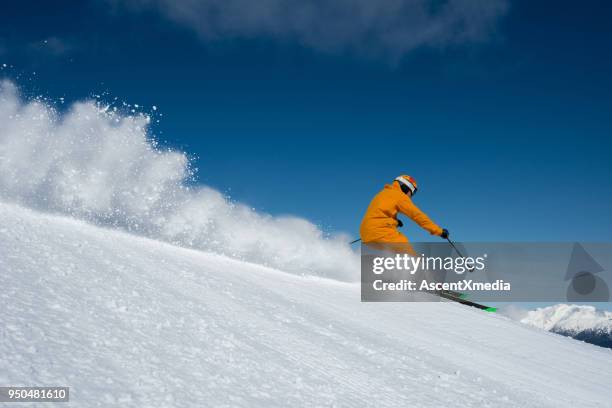 skiing groomed runs on a sunny day - downhill skiing stock pictures, royalty-free photos & images