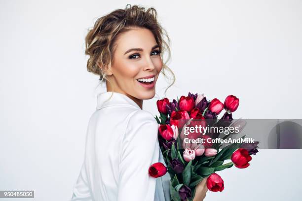 beautiful woman with perfect hairstyle - flower between teeth stock pictures, royalty-free photos & images