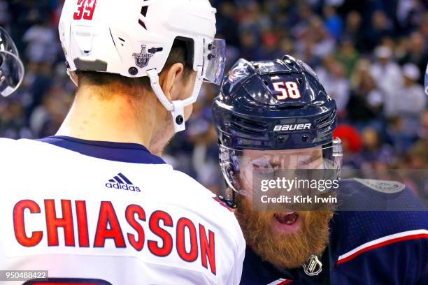 David Savard of the Columbus Blue Jackets congratulates Alex Chiasson of the Washington Capitals at the end of Game Six of the Eastern Conference...