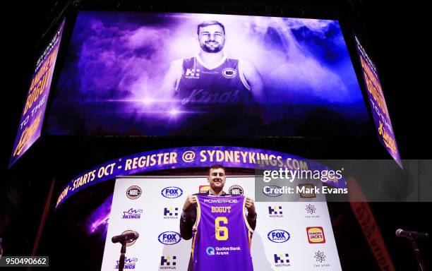 Andrew Bogut holds up a Kings singlet as he is unveiled as a Sydney Kings player at Qudos Bank Arena on April 24, 2018 in Sydney, Australia.