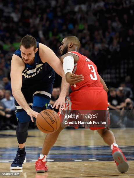 Chris Paul of the Houston Rockets defends against Nemanja Bjelica of the Minnesota Timberwolves during the fourth quarter in Game Four of Round One...