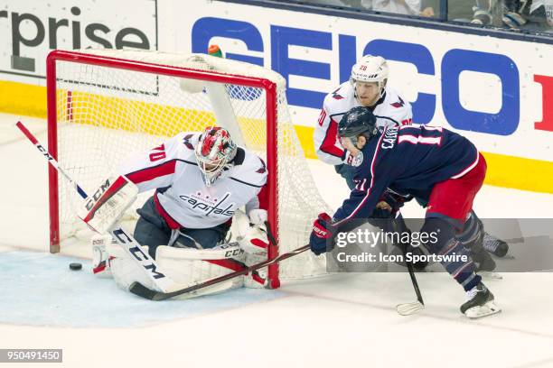 Columbus Blue Jackets left wing Matt Calvert attempts a shot as Washington Capitals goaltender Braden Holtby defends during game 6 in the first round...