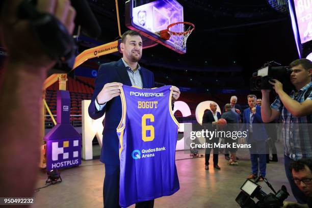 Andrew Bogut poses for photographs with a Kings singlet as he is unveiled as a Sydney Kings player at Qudos Bank Arena on April 24, 2018 in Sydney,...