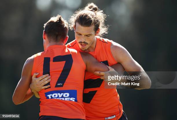 Zac Langdon and Phil Davis of the Giants take part in a drill during a GWS Giants Training Session at WestConnex Centre on April 24, 2018 in Sydney,...