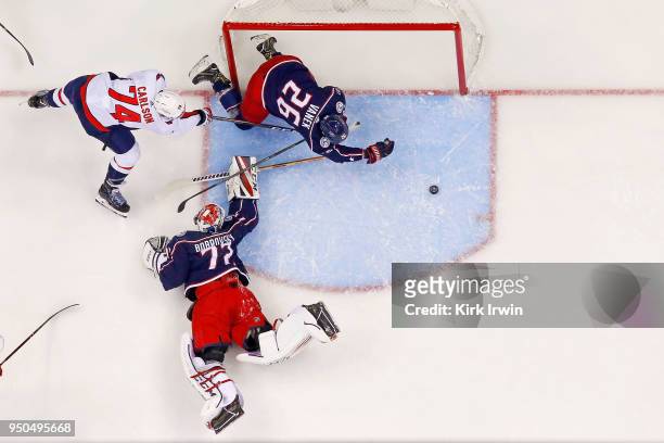 Thomas Vanek of the Columbus Blue Jackets slides the puck away from the net before John Carlson of the Washington Capitals is able to shoot the puck...