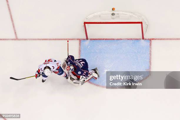 Sergei Bobrovsky of the Columbus Blue Jackets stops a deflected shot from T.J. Oshie of the Washington Capitals in Game Four of the Eastern...