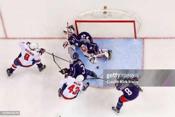 Sergei Bobrovsky of the Columbus Blue Jackets makes a save as Seth Jones of the Columbus Blue Jackets attempts to keep Alex Ovechkin of the...