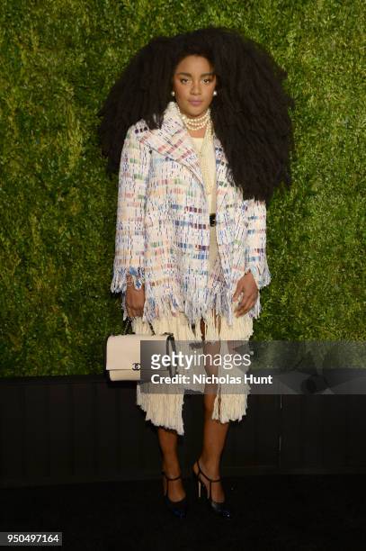 Quann wears a multicolored fantasy tweed jacket, from the CHANEL Spring-Summer 2018 Act 2 Ready-to- Wear Collection with CHANEL Shoes, Bag, and...