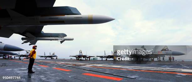This undated photo taken in April 2018 shows J15 fighter jets on China's sole operational aircraft carrier, the Liaoning, during a drill at sea. - A...