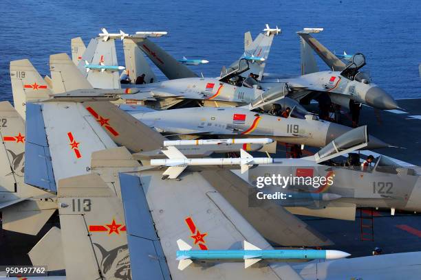 This undated photo taken in April 2018 shows J15 fighter jets on China's sole operational aircraft carrier, the Liaoning, during a drill at sea. - A...