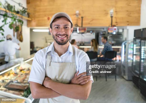 happy man working at a delicatessen - butcher portrait imagens e fotografias de stock