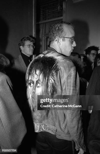 Artist Keith Haring wearing a jacket with a painting of Michael Jackson on the back at the opening of fashion designer Stephen Sprouse’s store at 99...