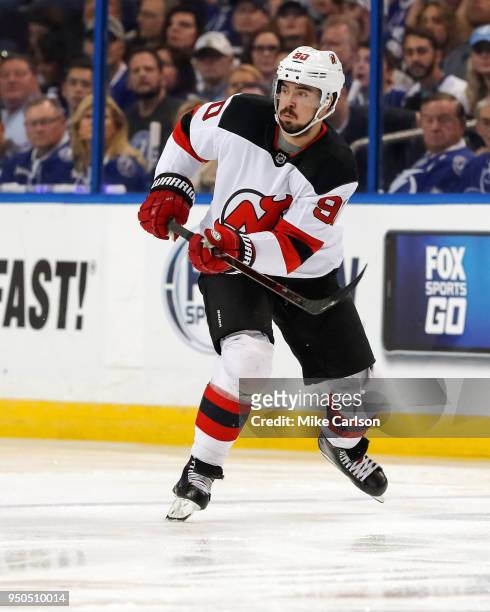Marcus Johansson of the New Jersey Devils looks up ice against the Tampa Bay Lightning in the first period of Game Five of the Eastern Conference...