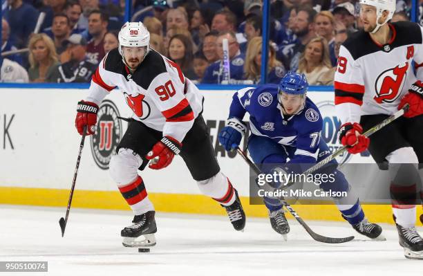 Marcus Johansson of the New Jersey Devils avoids the check of Anthony Cirelli of the Tampa Bay Lightning in the first period of Game Five of the...