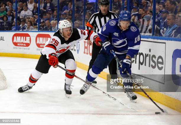 Ondrej Palat of the Tampa Bay Lightning avoids the check from Mirco Mueller of the New Jersey Devils in the second period of Game Five of the Eastern...