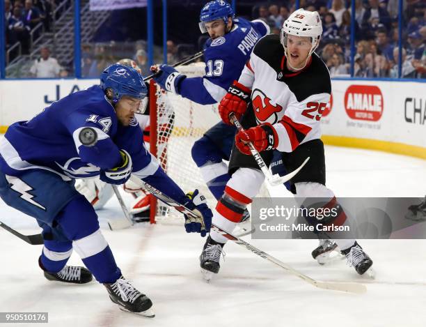 Mirco Mueller of the New Jersey Devils clears the puck past Chris Kunitz of the Tampa Bay Lightning in the second period of Game Five of the Eastern...