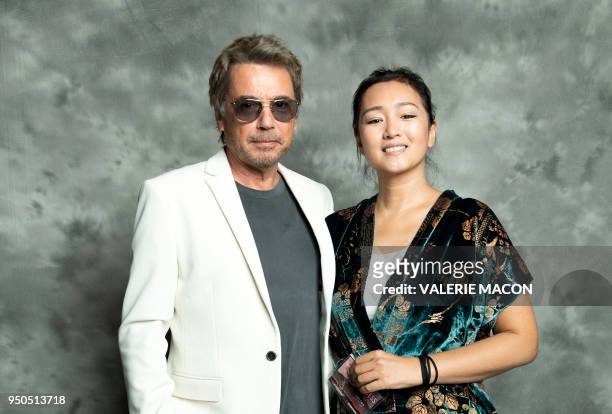 French composer Jean-Michel Jarre and actress Gong Li pose during the opening night of the 2018 COLCOA French Film Festival, April 23, 2018 at the...