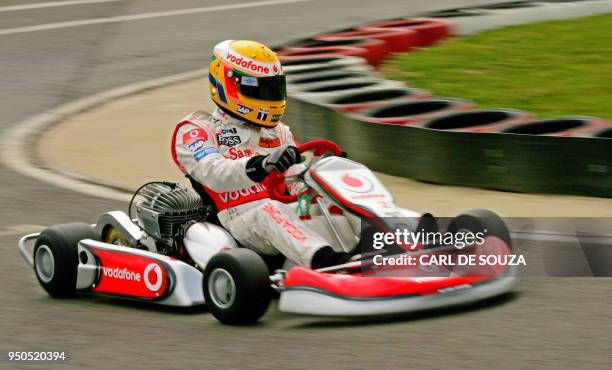 British F1 racing driver Lewis Hamilton races in a go-kart at the Daytona International karting track, in Milton Keynes, in southern England, 05 July...