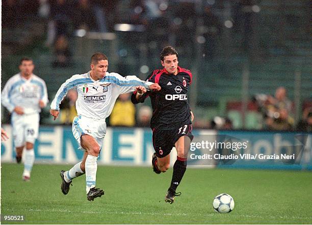 Francesco Coco of AC Milan speeds past Diego Simeone of Lazio during the Italian Serie A match played at the Stadio Olimpico, in Rome, Italy. The...