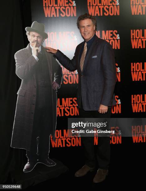 Actor Will Ferrell poses next to a cardboard cutout of actor John C. Reilly, dressed as the character Watson from the upcoming movie "Holmes &...