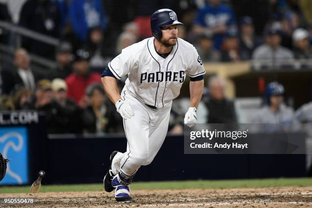 Chase Headley of the San Diego Padres hits a ninth inning game tying double at second base during the game against the Los Angeles Dodgers at PETCO...