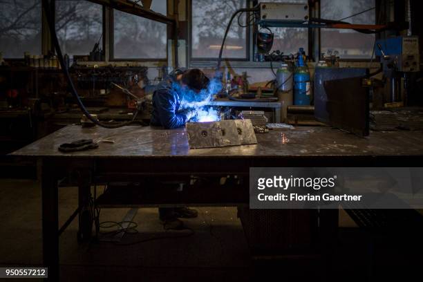 Worker welds metal in the workshop of a blacksmith on April 03, 2018 in Klitten, Germany.