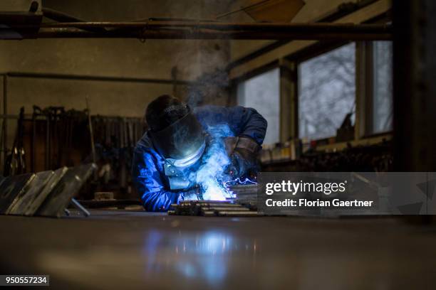 Worker welds metal in the workshop of a blacksmith on April 03, 2018 in Klitten, Germany.