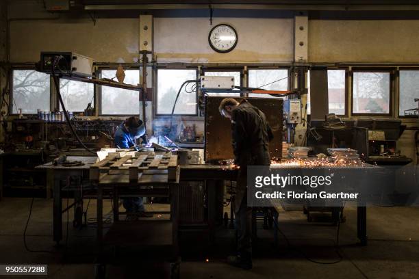 Two men do metalworking in the workshop of a blacksmith on April 03, 2018 in Klitten, Germany.