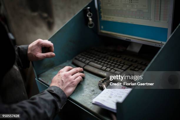 Craftsman is working on a computer in the workshop of a blacksmith on April 03, 2018 in Klitten, Germany.