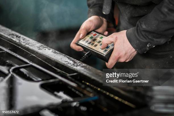Worker operates a remote control for a laser cutter in a blacksmith shop on April 03, 2018 in Klitten, Germany.