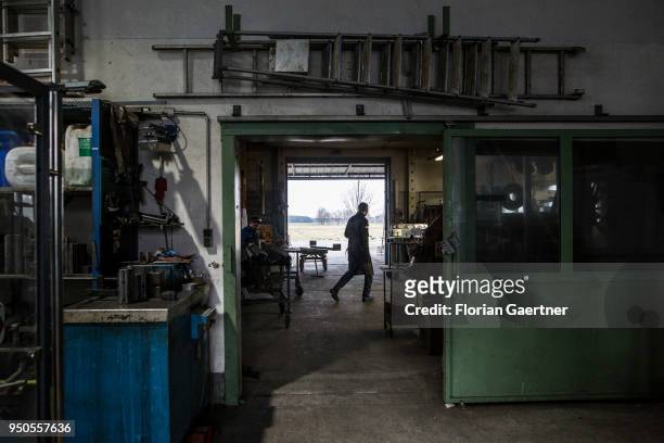 Worker walks through the workshop of a blacksmith on April 03, 2018 in Klitten, Germany.