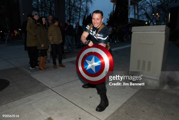 Fan waits in line in a Captain America costume on opening night of the Marvel: Universe of Super Heroes exhibit at MoPop on April 20, 2018 in...