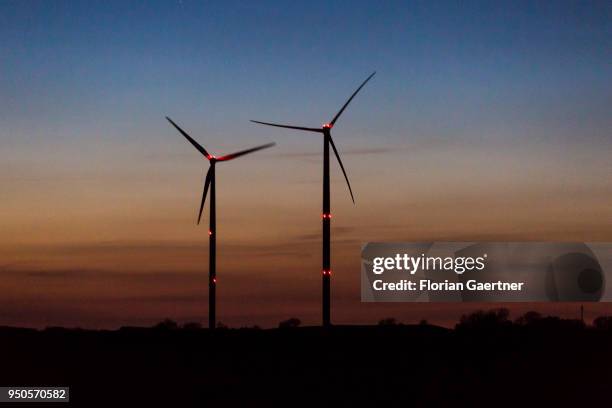 Wind turbines are pictured at dusk on April 21, 2018 in Rostock, Germany.