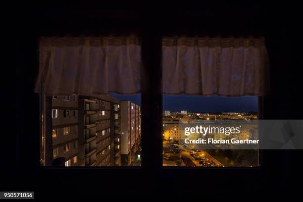 Blocks of flats are pictured through a window at dusk on April 20, 2018 in Stendal, Germany.