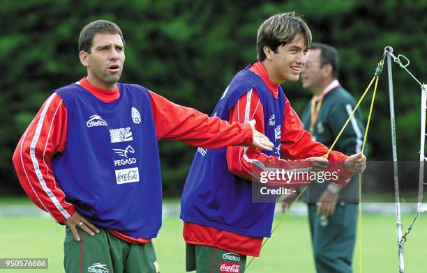 Mexican soccer players Alberto Gracia Aspe and Cesario Victorino prepare the net during a team practice at Carmel Club in Bogota, Colombia on 28 July...