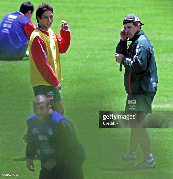 Head coach of the Mexican soccer team, Javier Aguirre talks to Ignacio Hierro while Oscar Perez runs after the ball, 27 July 2001, at the Carmel de...