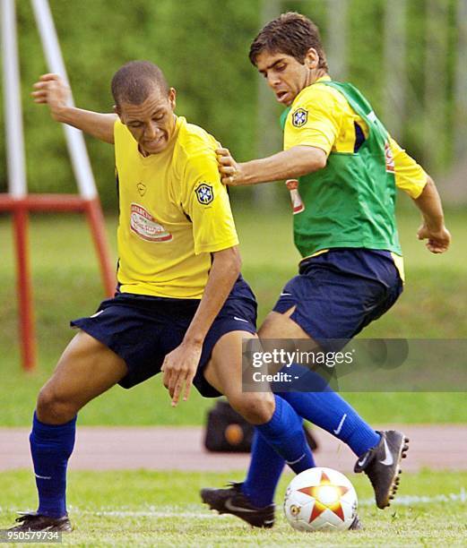Players of the Brazilian soccer team, Eduardo Costa and Juninho Pernambucano fight for the ball during a practice, 17 July 2001, in Cali Colombia....
