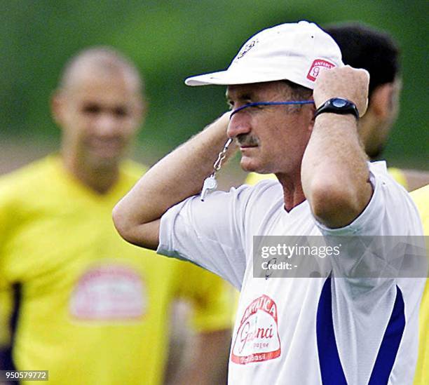 Luis Felipe Scolari, head coach of the Brazilian soccer team, hangs a whistle on his neck, 17 July 2001, during a practice in Cali, Colombia. Brazil...