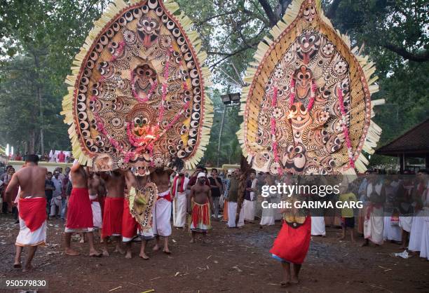 In this photo taken on April 21 Indian performers take part in the Bhairavi Kolam dance, wearing large masks built by artisans for the event, to...