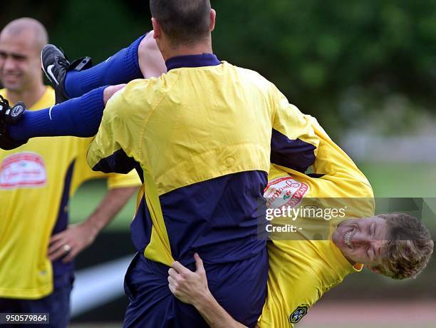 Marcos, goalkeeper of the Brazilian soccer team, and Juninho joke around while watched by Cris, 17 July 2001, during a practice in Cali, Colombia....
