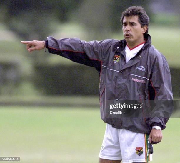 Head coach of the Bolivian soccer team, Carlos Aragones, gives orders 10 July 2001 during a practice in Rio Negro, close to Medellin, Colombia, for...