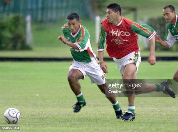 Players of the Bolivian soccer team, Eduardo Jiguchi and Luis Camacho fight for the ball 10 July 2001 during a practice in Rio Negro, close to...