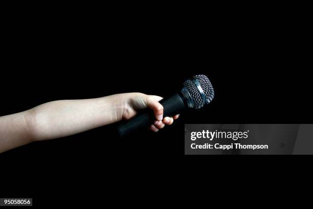 microphone arm - holding microphone stock pictures, royalty-free photos & images