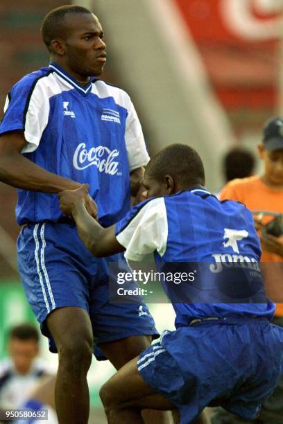 Player of Italy's Cagliari team, David Suazo , and player of Uruguay's Nacional team, Milton "Tyson" Nunez, exercise for their crucial qualifying...