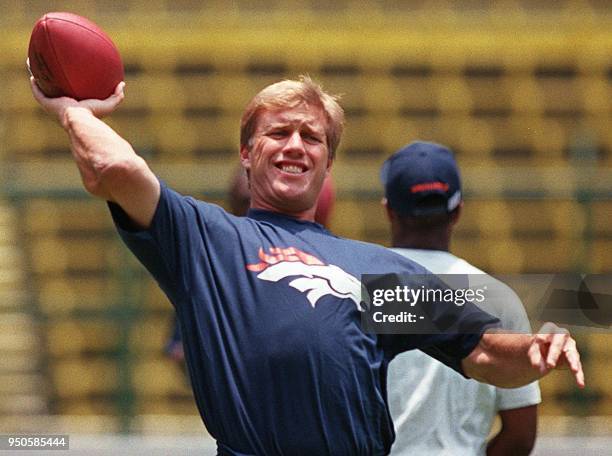 Denver Broncos quarterback John Elway throws the ball as the Broncos work out 03 August at Aztec Stadium in Mexico City. The Broncos will play the...
