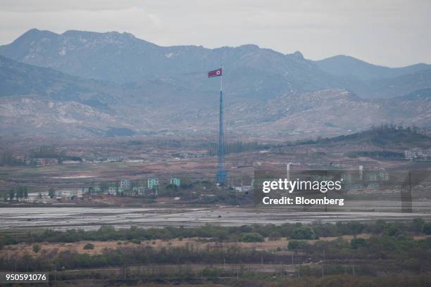 North Korean flag flying over North Korea's Gijungdong village is seen from the Dorasan Observatory in the Demilitarized Zone in Paju, South Korea,...