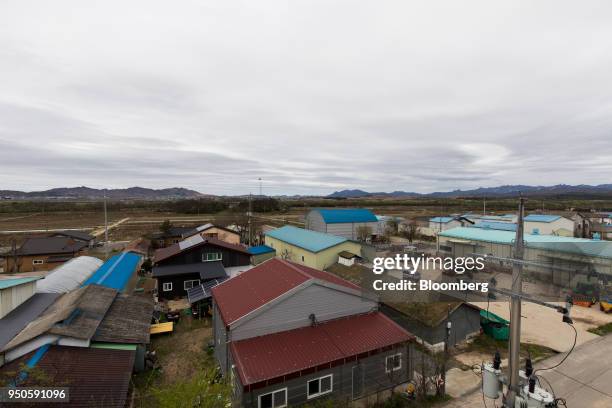 North Korean flag flying over North Korea's Gijungdong village, rear, is seen from the Daeseong-dong village in the Demilitarized Zone in Paju, South...