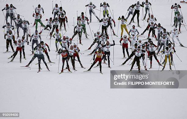 Competitors take the start of the the women's 15 km free mass start of the cross-country World Cup in Val di Fiemme at Lago di Tesero, 15 January...