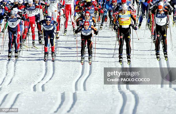 Skiers compete in the World Cup men's 30km pursuit cross country race in Tesero 11 December 2004. German Axel Teichmann won the race, ahead of Jens...