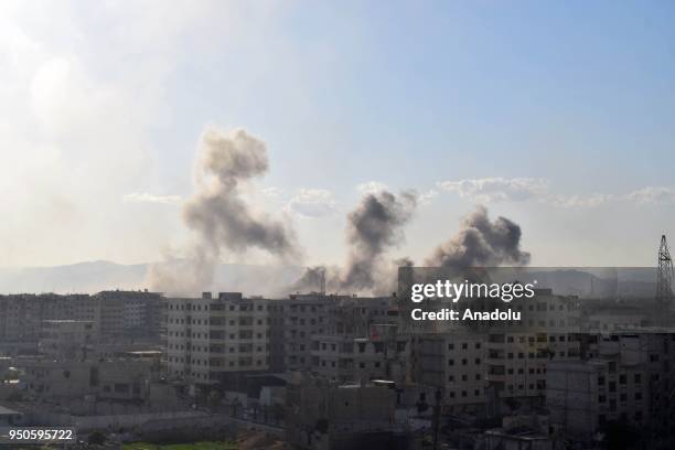 Smoke rises after Assad regime forces carried out airstrikes over the Daesh controlled part of Yarmouk refugee camp where Palestinian refugees take...